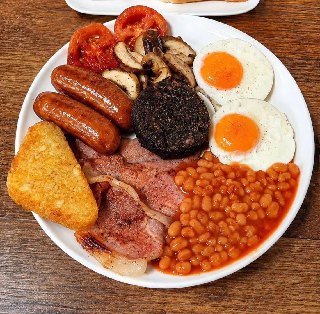 A full English breakfast with sausages, bacon, black pudding, eggs, beans and toast
